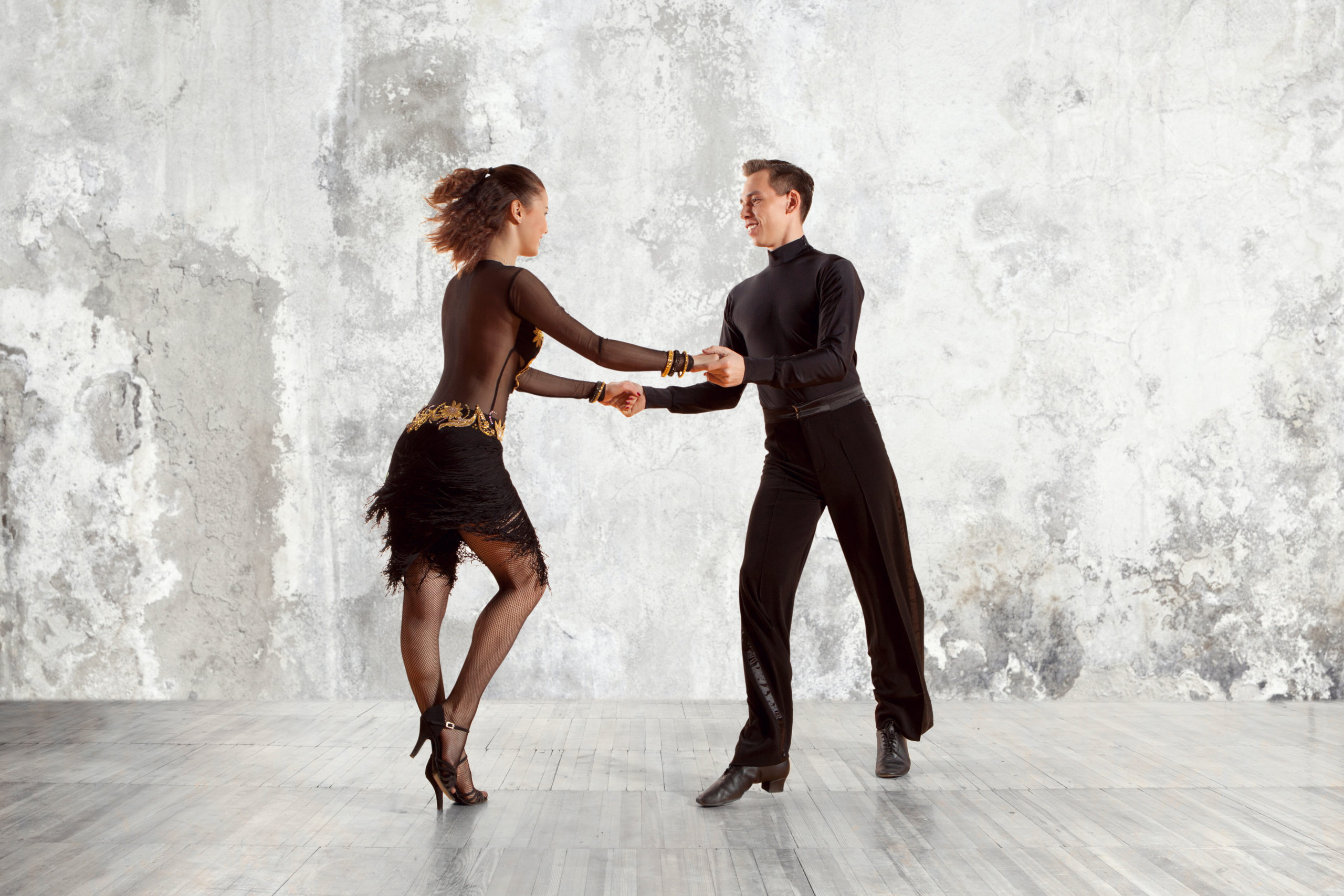 Beautiful couple in the active ballroom dance on wall